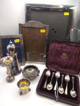 A set of six silver teaspoons with shell pattern bowls, cased, retailed by Botly & Lewis, together