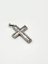 An 18ct white gold and diamond cross pendant, set with baguette and brilliant-cut diamonds of