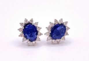 A pair of 18ct white gold, diamond, and sapphire earrings, set with oval-cut sapphires of