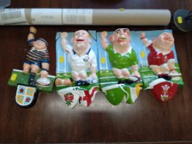 A group of four novelty rugby player clay wall plaques. Some restoration needed. (4)