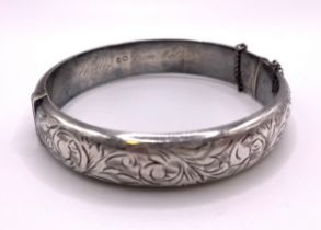 A silver hinged bangle / bracelet, hallmarked Chester 1958, inscribed 'Phyllis from Mother',