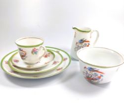 An Epiag Czechoslovakian porcelain part tea service decorated with birds and flower with green and