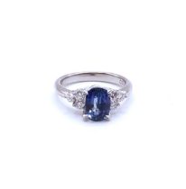 A platinum, diamond and sapphire ring, set with a mixed oval-cut blue sapphire of approximately 2.30