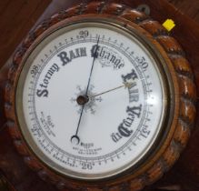 A Victorian oak aneroid barometer with rope-twist border detail