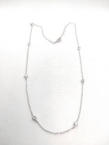 Extended silver necklace with spectacle-set white cubic zirconia.