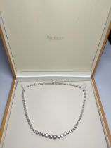 A 9ct white gold graduated Round Brilliant Cut diamond Riviere-style necklace, boxed. Diamonds 12.