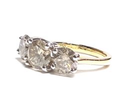 An 18ct yellow and white gold Round Brilliant Cut diamond trilogy ring. Diamonds 3.67ct. Certificate