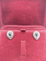 A pair of silver-gilt pear drop shaped stud earrings set with pear shaped sapphires and diamond