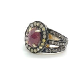 An oval pink tourmaline and diamond dress ring in silver. Tourmaline 1.68ct. Rose-cut dimaonds 1.