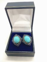 A pair of vintage-styled silver gilt stud earrings set with large oval turquoise, round-cut