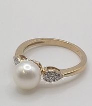 A 9ct gold cultured pearl and multi-set diamond ring. Round cut diamonds 0.10ct. Size N