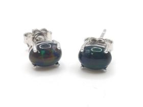 A pair of cabochon Ethiopian black opal studs in silver.
