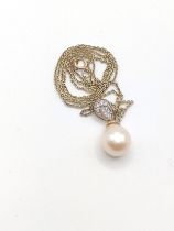 A 9ct yellow gold necklace with a suspended pear drop cultured pearl and round-cut diamond-set bale,