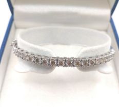 A 9ct white gold hinged bangle set with round brilliant cut diamonds, of approximately 2.21 carats