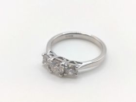 A certificated 18ct white gold graduated round brilliant cut diamond trilogy ring, boxed. Diamonds