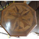 An octagonal table with marquetry. 74cm x 56cm