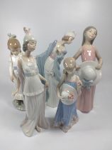 Four Lladro figures of girls and young ladies, 20cm to 26cm (one finger chipped), and Nao girl