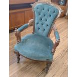 A green velour button-back parlour open arm chair on casters.