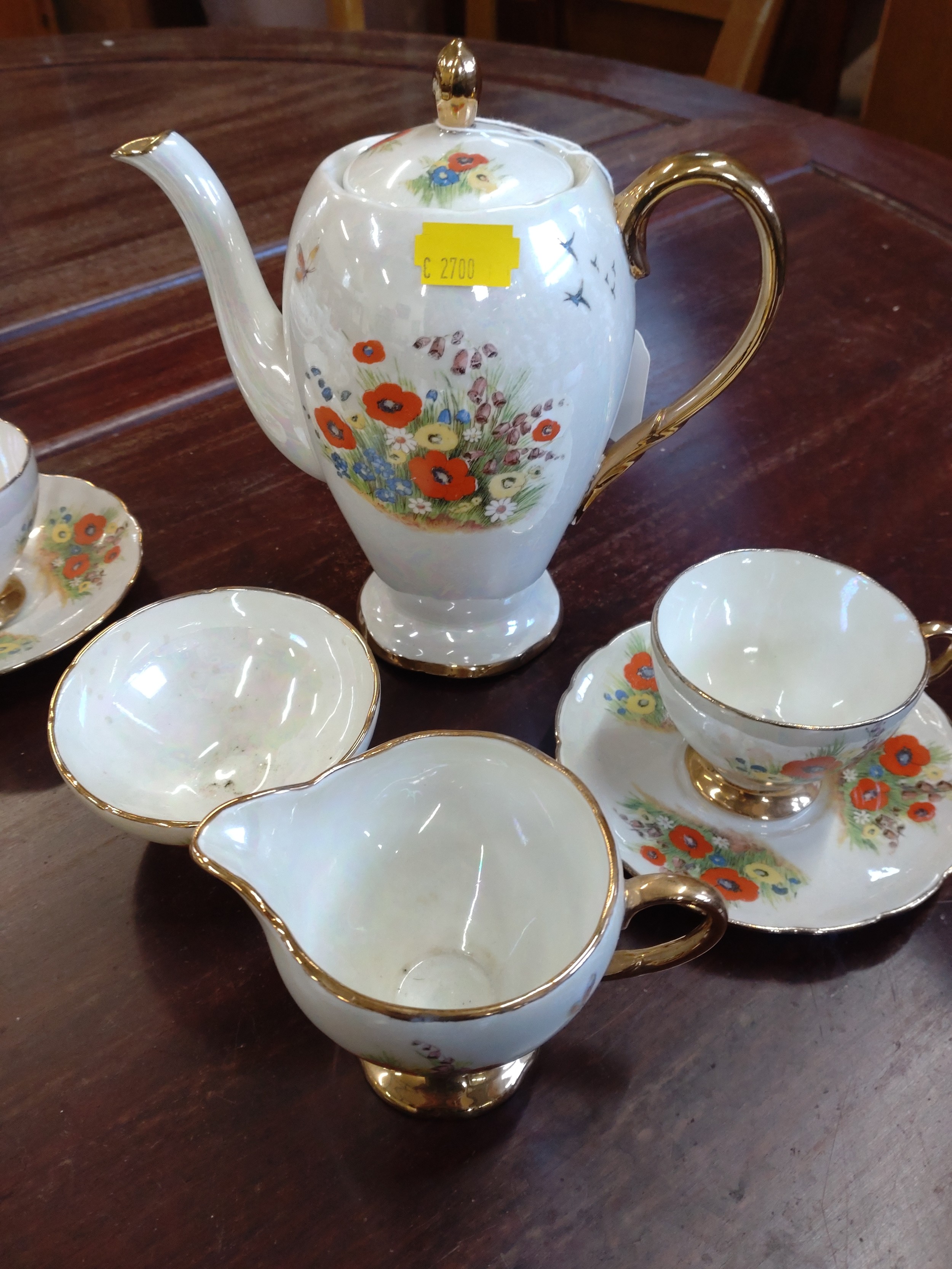 A lustre coffee set with floral decoration and a part tea service (lacks teapot). (34)