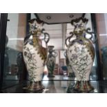 A pair of Oriental vases with floral decoration,40cm, one with some repair. (2)