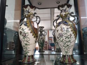 A pair of Oriental vases with floral decoration,40cm, one with some repair. (2)