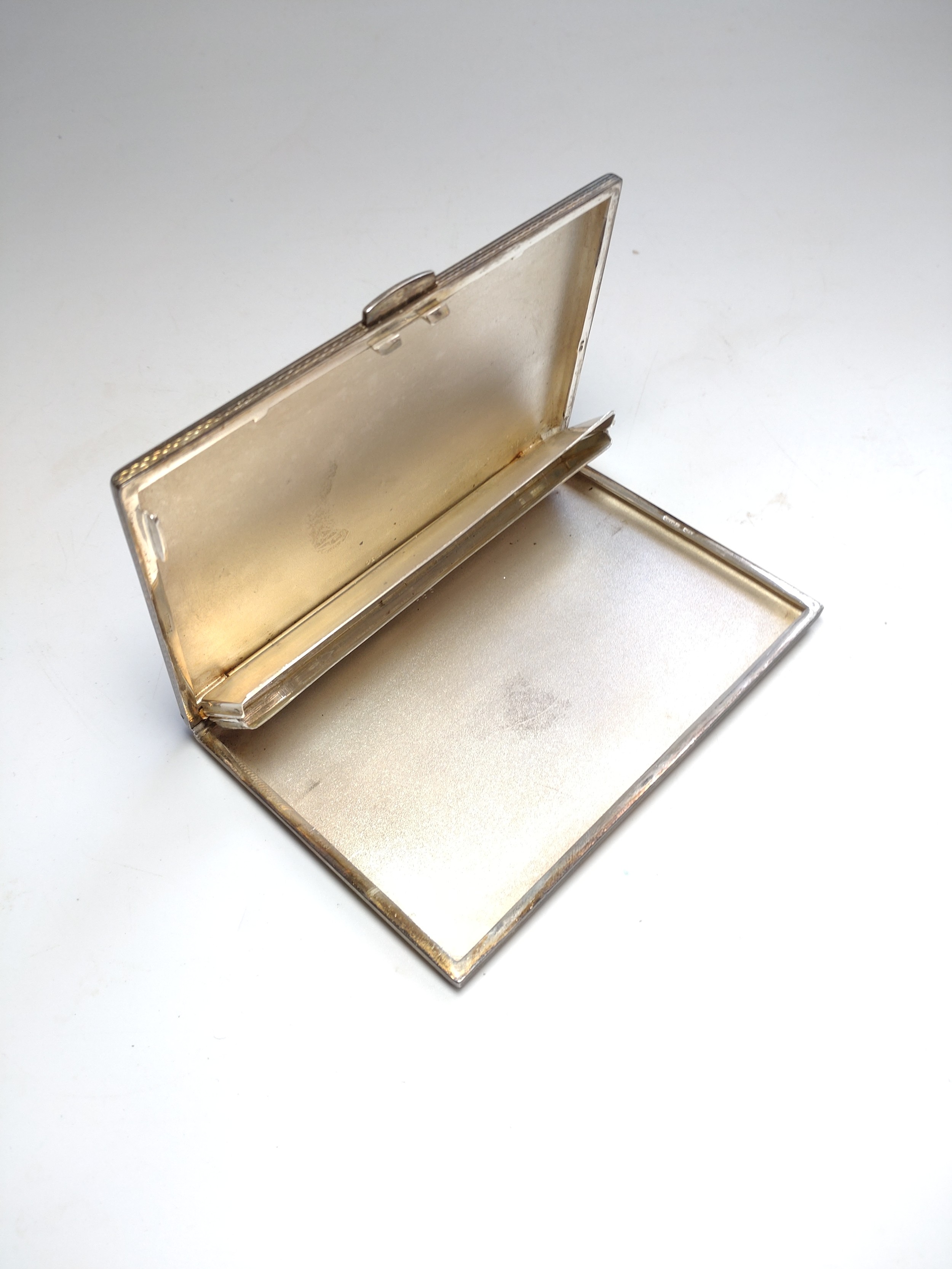 A Sterling silver cigarette case. Import marks. circa 1930. Engine turned decoration.