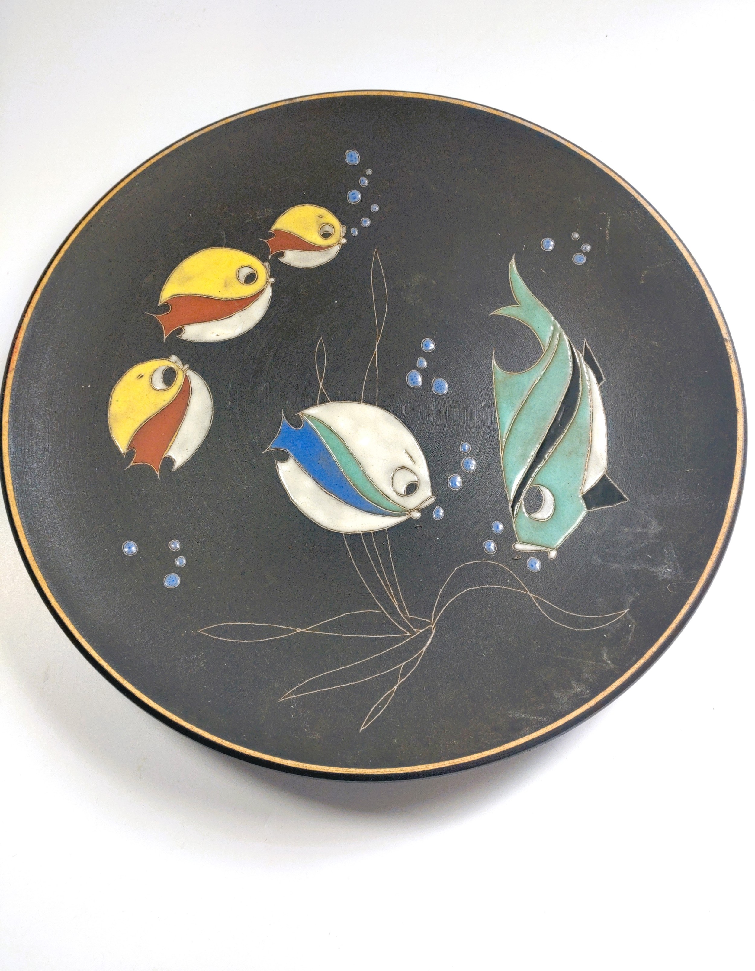 A black Ruscha dish with lava glaze fish design. 27cm diameter.