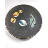 A black Ruscha dish with lava glaze fish design. 27cm diameter.