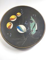 A black Ruscha dish with lava glaze fish design. 27cm diameter.