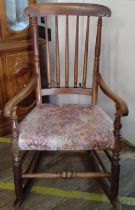 A rocking chair with upholstered seat