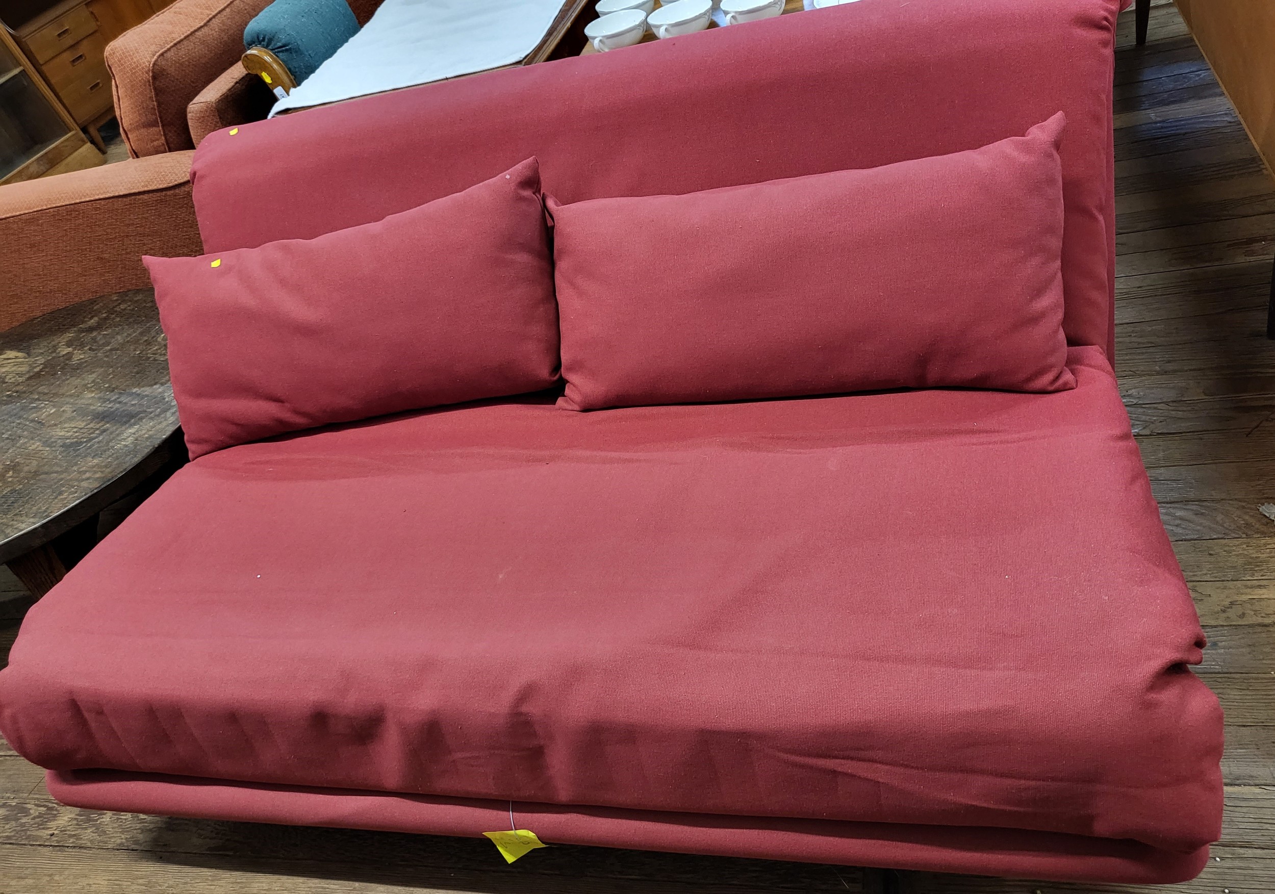 A red sofa bed. 80cm x 160cm x 106cm.