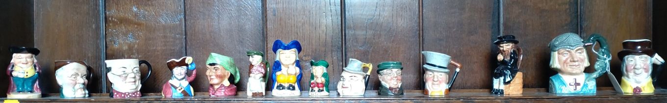 Fourteen character jugs including Royal Doulton St. George and Artone Fagin. (14)