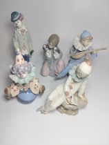 Two Lladro Clowns 17.5cm and 22cm Lladro girl with puppy 16cm, and two Nao figures , 16cm and