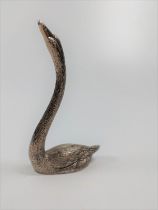 A white metal casting of a swan.