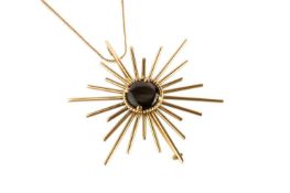 A black star sapphire pendant/brooch, the circular black star sapphire in ropetwist edged claw