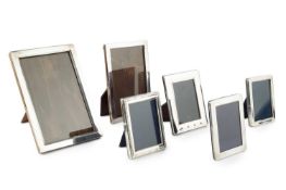 A collection of six silver rectangular photograph frames, the largest of plain bevelled design,