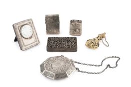 An American silver octagonal powder compact, engraved with scrolling foliage and having chain