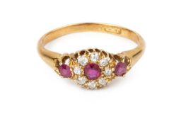 A ruby and diamond cluster ring, the circular mixed-cut rubies framed by old-cut diamonds, yellow