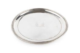 A George III silver circular teapot stand, with beaded border, engraved crest to the centre and
