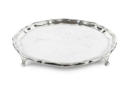 A George VI silver salver, with shaped border and reeded shaped feet, by Reid & Sons Ltd, London