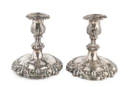 A pair of early Victorian silver dwarf candlesticks, the knopped stems and weighted bases relief