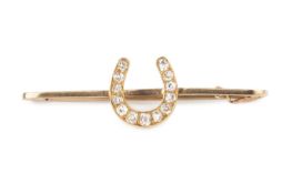 A diamond horseshoe bar brooch, highlighted with graduated old-cut diamonds, yellow precious metal