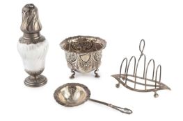 A late Victorian silver sugar bowl, repoussé decorated with flowers and scrolls, on shell capped pad