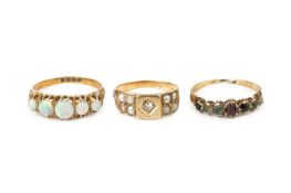 Three gem set dress rings, comprising a diamond and half pearl half hoop ring, a 'Dearest' half hoop