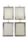 A set of four George V silver rectangular photograph frames, with engine turned decoration, vacant