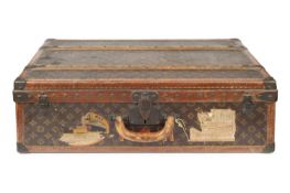 A Louis Vuitton suitcase, with studded leather bound edges and gilt printed logo decoration, the
