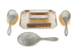 A silver backed dressing table set and tray, with engine turned decoration, comprising tray, hand