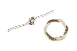 Two sapphire and diamond brooches, the first of wreath design, with alternating channels of