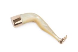 A 19th century mother o'pearl pipe tamper, in the form of a female leg, with yellow metal mounts (