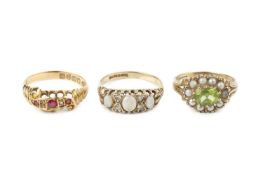 An opal and diamond half hoop ring, the graduated oval cabochon opals spaced by pairs of round